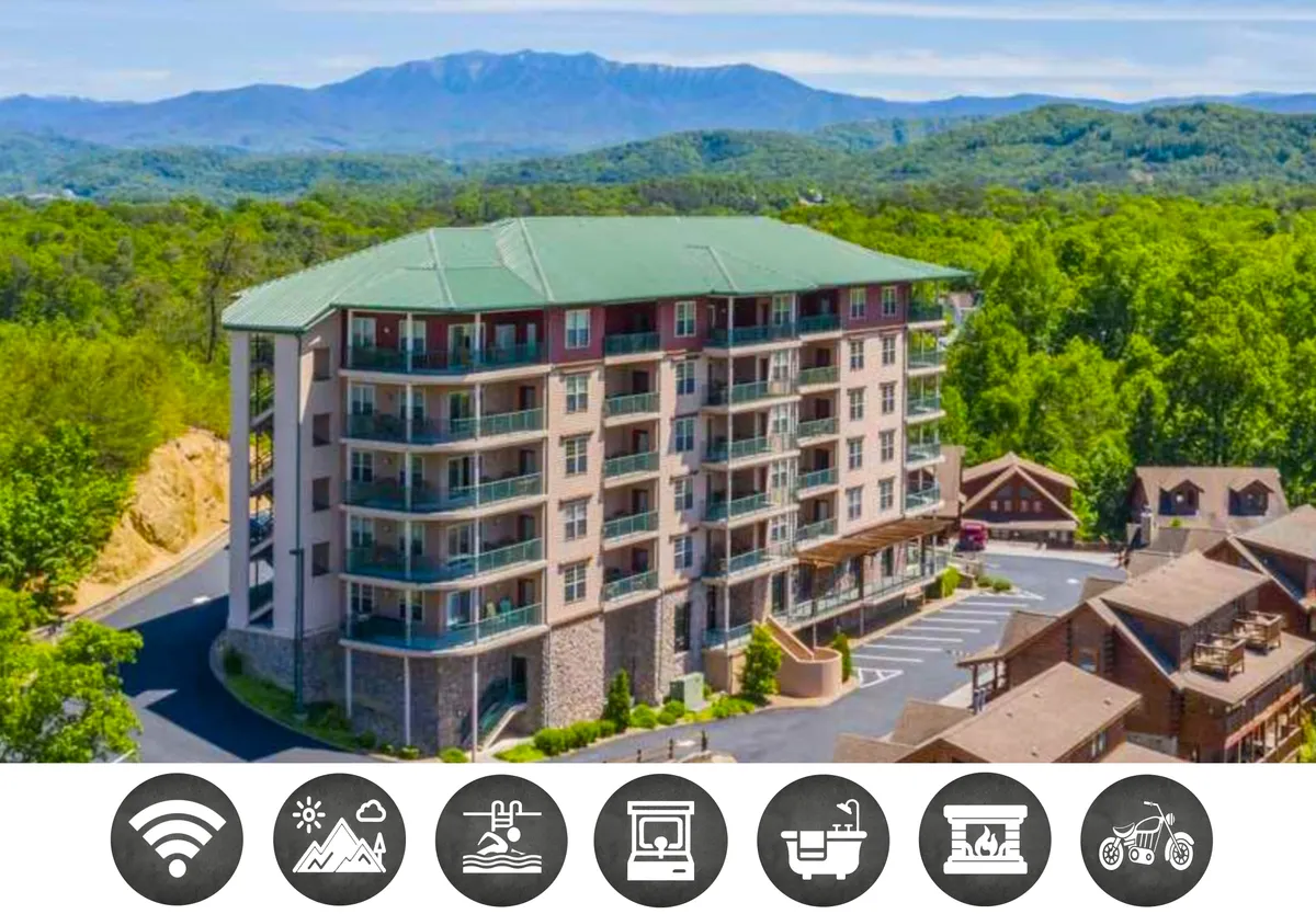 The image showcases a multi-story condo building nestled amid lush greenery, with a stunning mountain backdrop. Spacious balconies invite relaxation, and the setting is peaceful and welcoming, ideal for families or groups seeking both adventure and tranquility.
