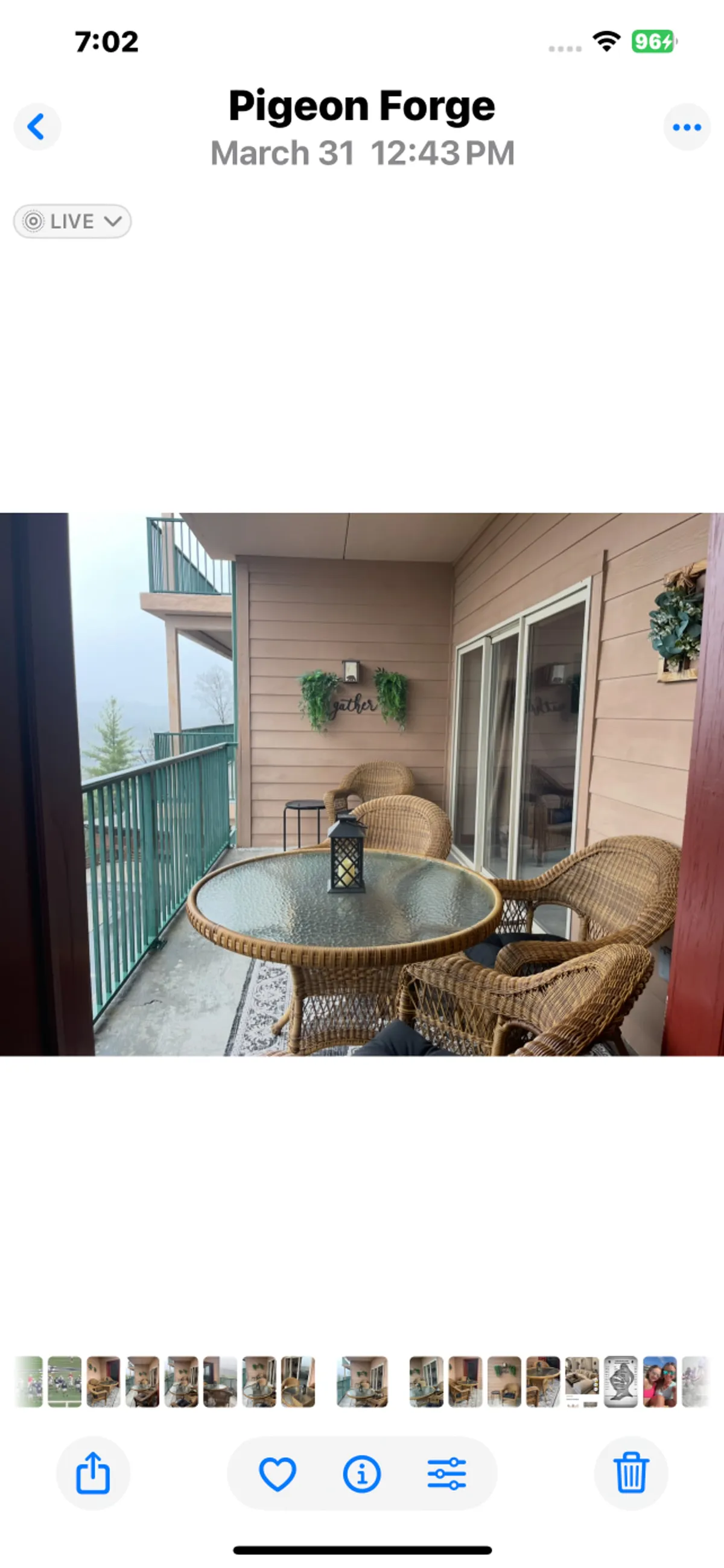 An inviting patio area with wicker chairs, a glass table, and a decorative wall hanging offers a comfortable space for morning coffee or evening stories. The setting is cozy yet open, bridging the indoors and outdoors in a way that appeals to families looking to relax and connect throughout their stay.